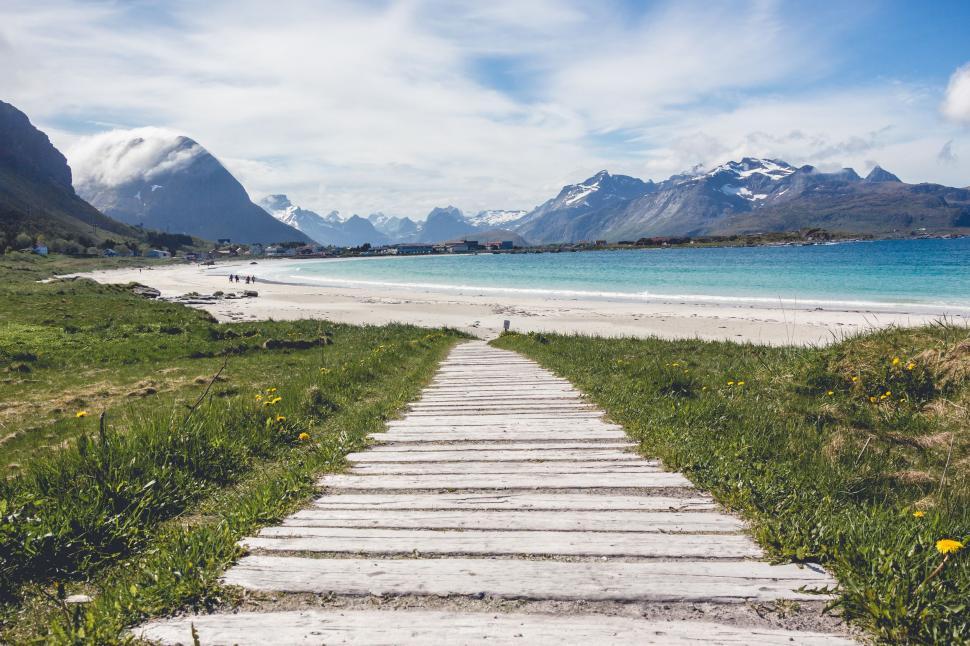 Free Image of Wooden Path Leading to Beach With Mountains 