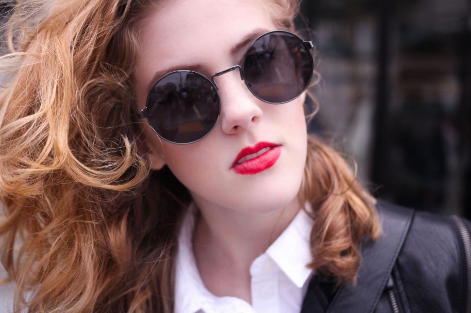 Free Image of Woman With Red Hair Wearing Sunglasses and Black Jacket 