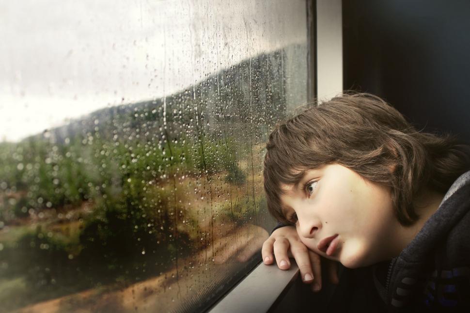 Free Image of Boy Looking Out of a Train Window 