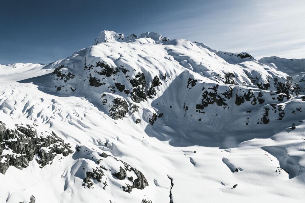 Free Image of Snowboarder Descending Snowy Mountain 