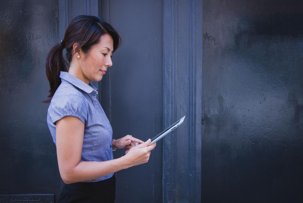 Free Image of Woman in Blue Shirt Holding Tablet 