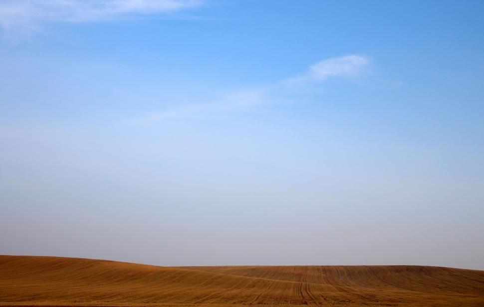 Free Image of Large Open Field With Blue Sky 