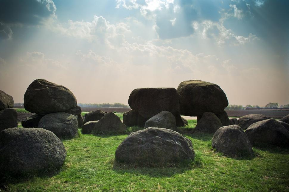 Free Image of Large Rocks Resting on Lush Green Field 