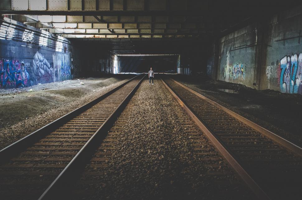 Free Image of Person Standing on Train Track in Tunnel 