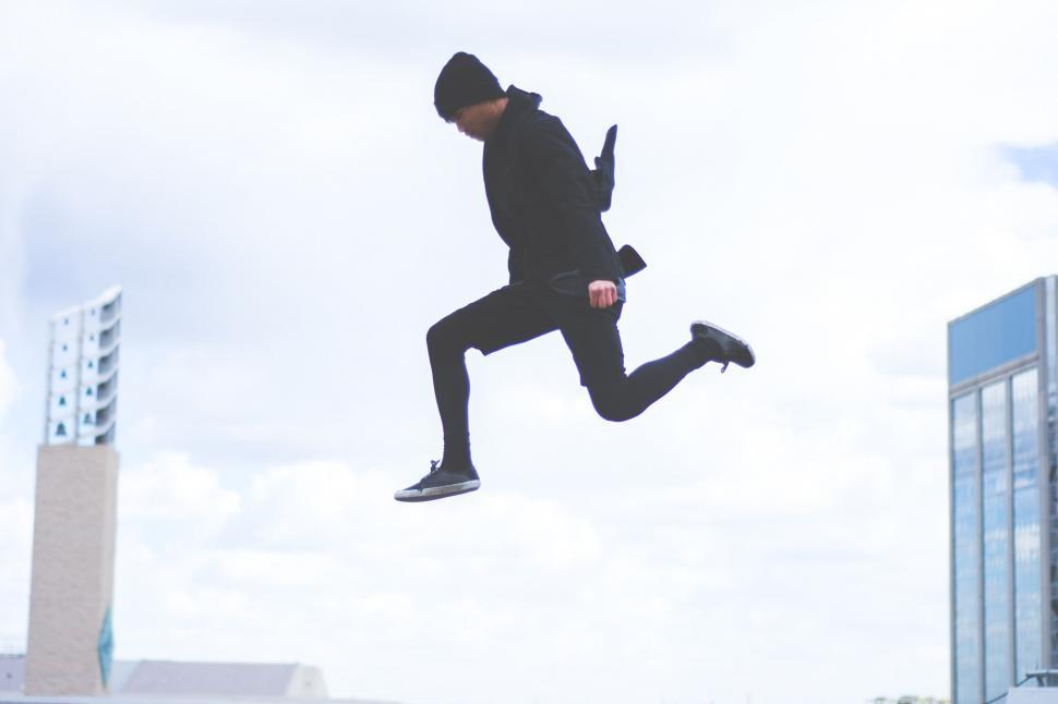 Free Image of Man Jumping in the Air With Cell Phone 