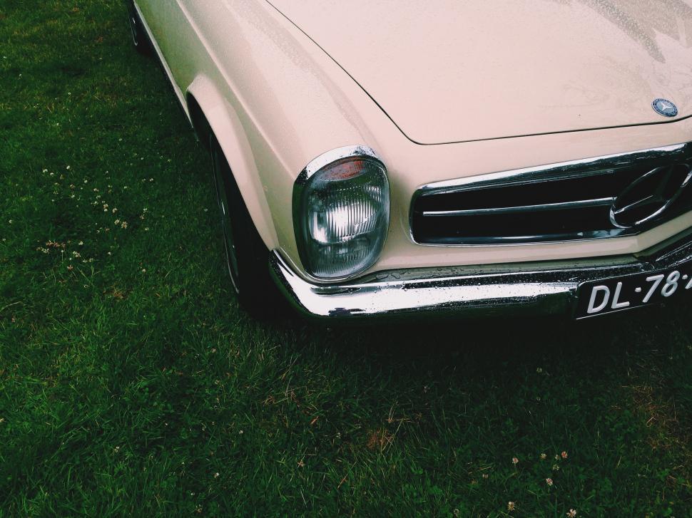 Free Image of Vintage Car Parked in Grassy Field 