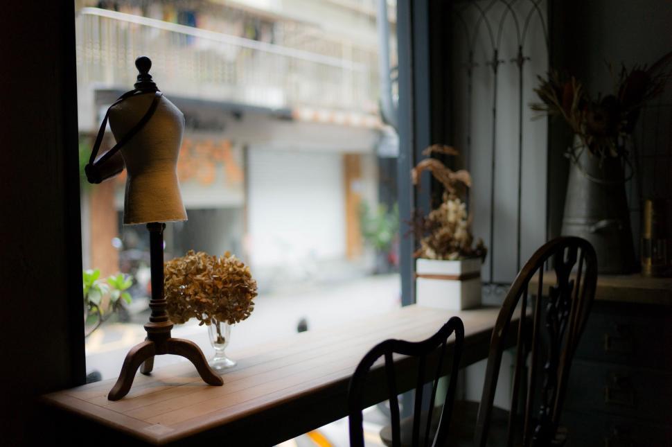 Free Image of Mannequin on Table in Front of Window 