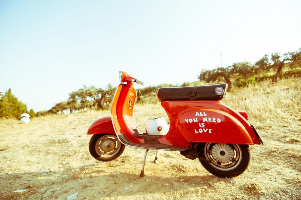 Free Image of Red Scooter Parked on Dirt Road 