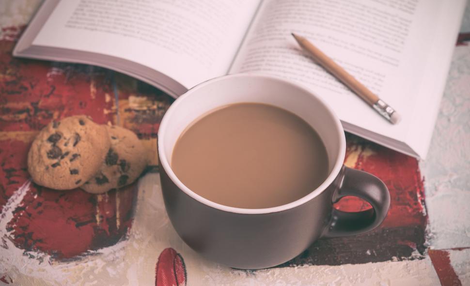 Free Image of Coffee Cup and Book on Table 