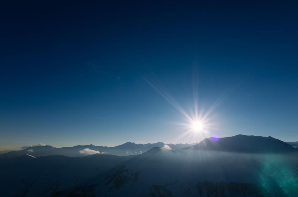 Free Image of Sun Shining Over Mountain Range 