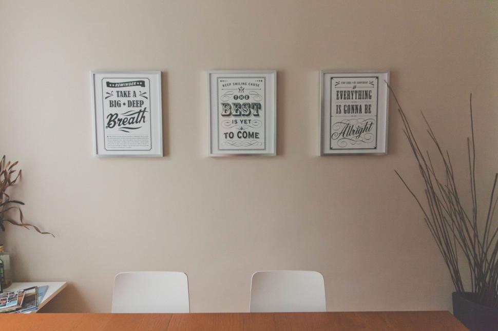 Free Image of Dining Room Table With Four Chairs and Three Posters 