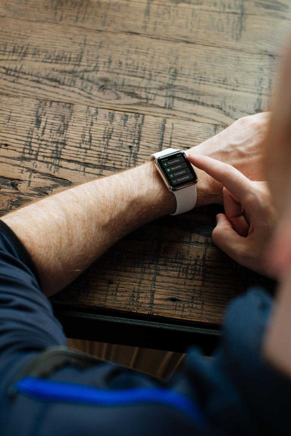Free Image of Man Sitting at Table With Smart Watch 