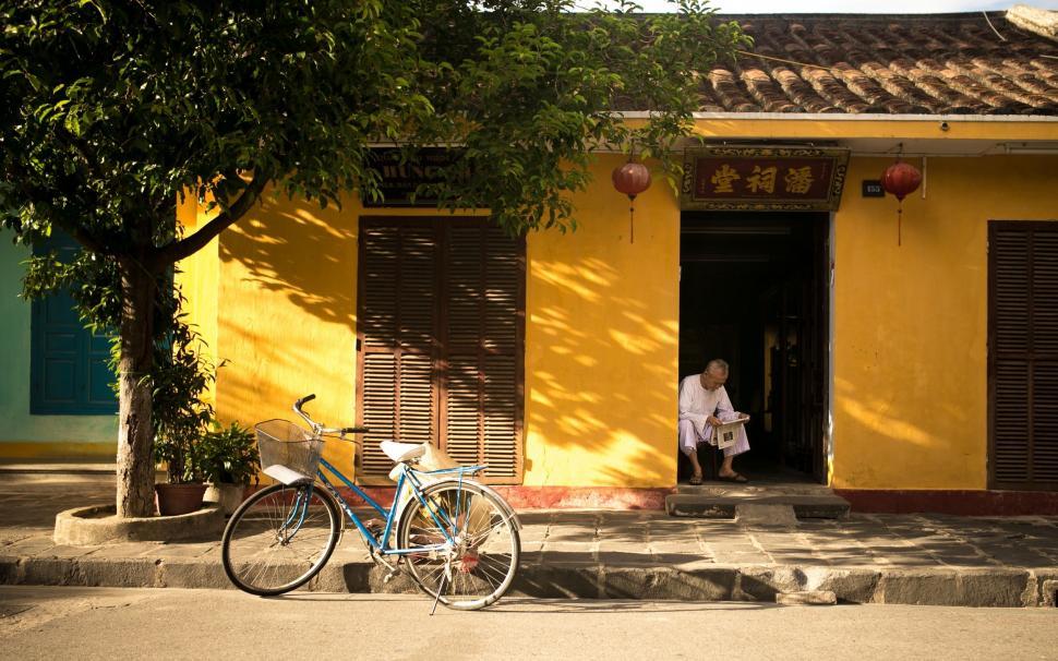 Free Image of Bicycle Parked in Front of Yellow Building 