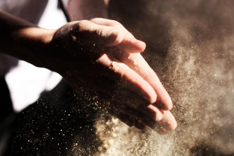 Free Image of Person Throwing Sand Into the Air 