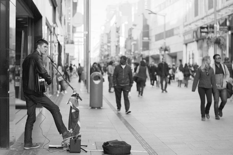 Free Image of Man Standing by Guitar on Street 