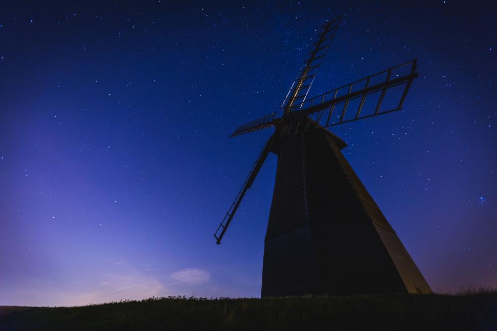 Free Image of Windmill Spinning in Field at Night 