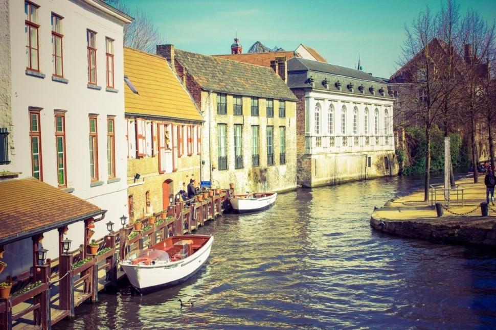 Free Image of Two Boats Docked in Canal Between Two Buildings 