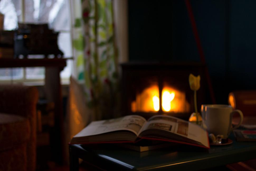 Free Image of Open Book by Fireplace 