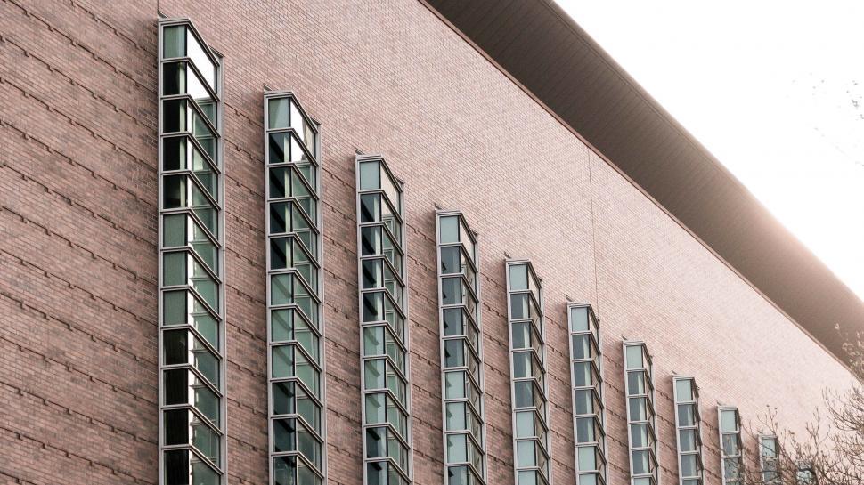 Free Image of Tall Brick Building With Many Windows 
