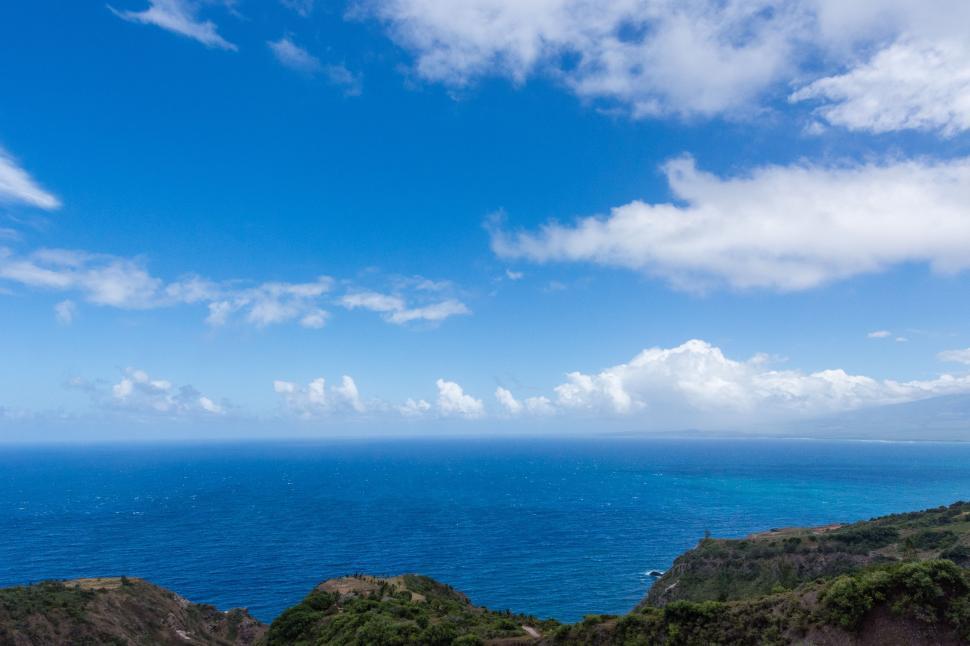 Free Image of Overlooking the Ocean From a Hilltop 