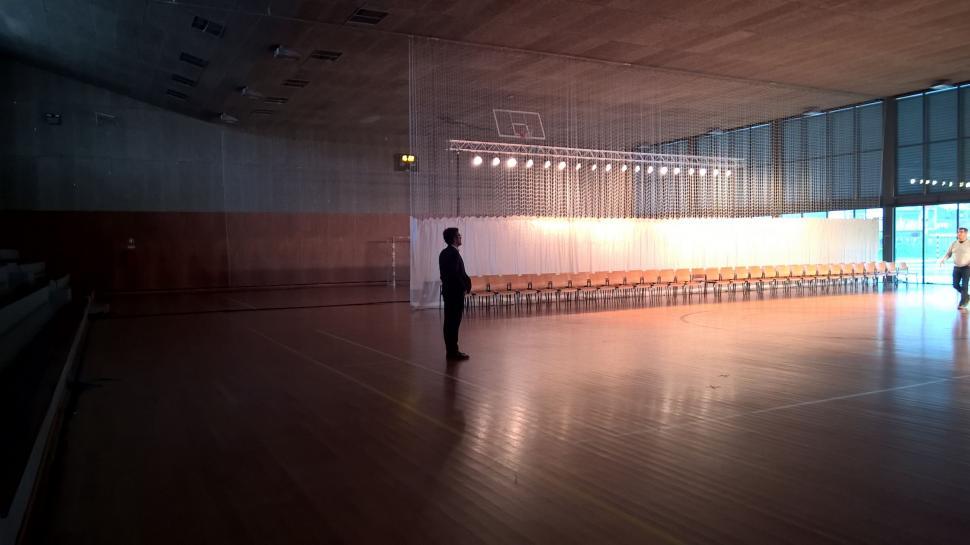 Free Image of Person Standing in Large Room With Chairs 