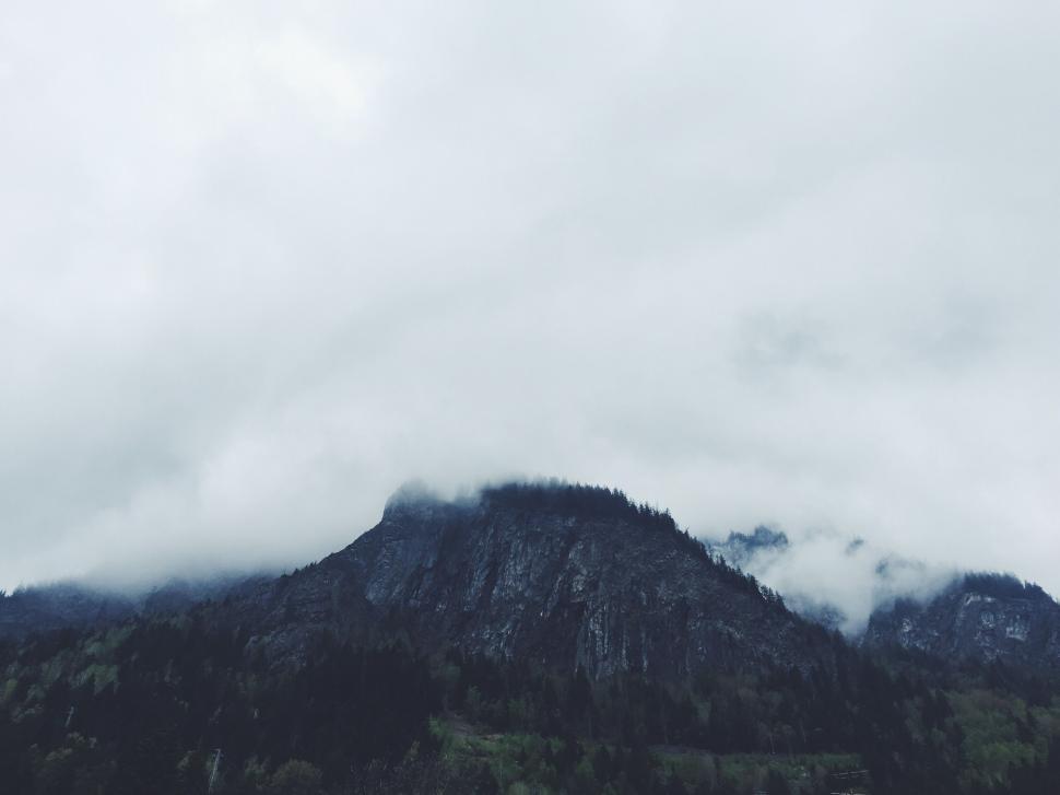 Free Image of Mountain Shrouded in Fog and Clouds on a Cloudy Day 