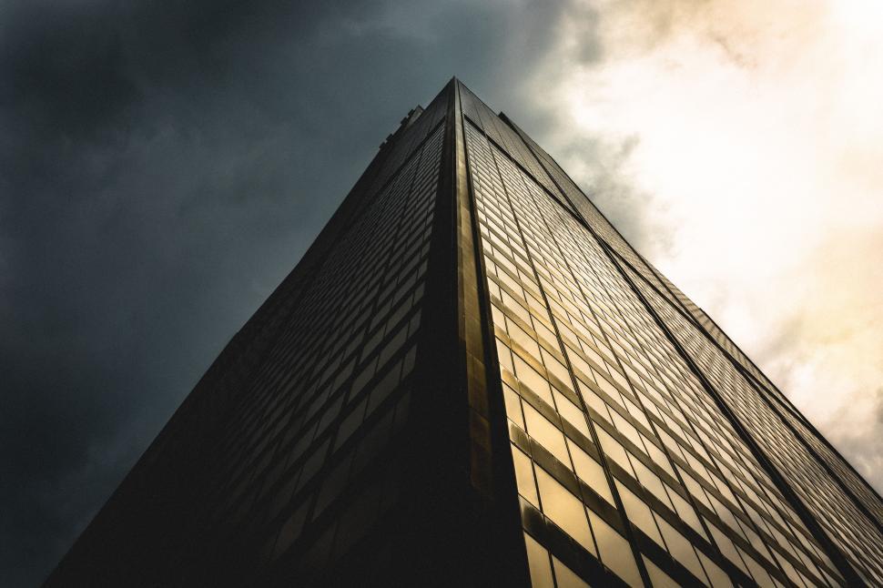 Free Image of Tall Building Under Cloudy Sky 