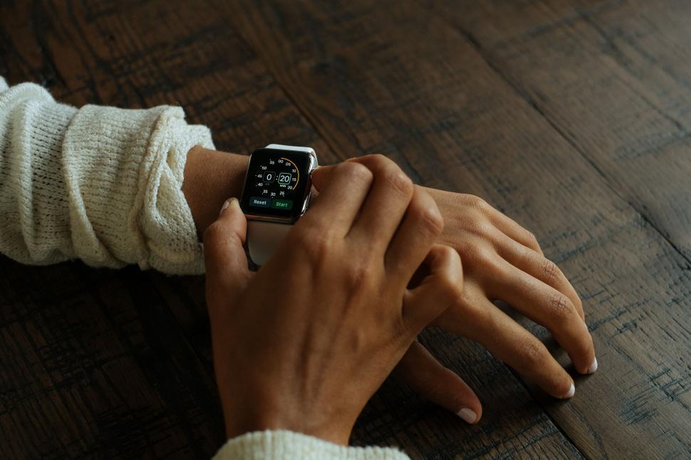 Free Image of Person Holding Smart Watch on Wrist 