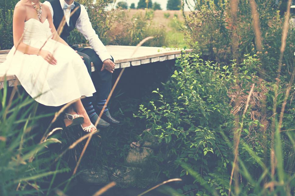 Free Image of Bride and Groom Sitting on a Bench 