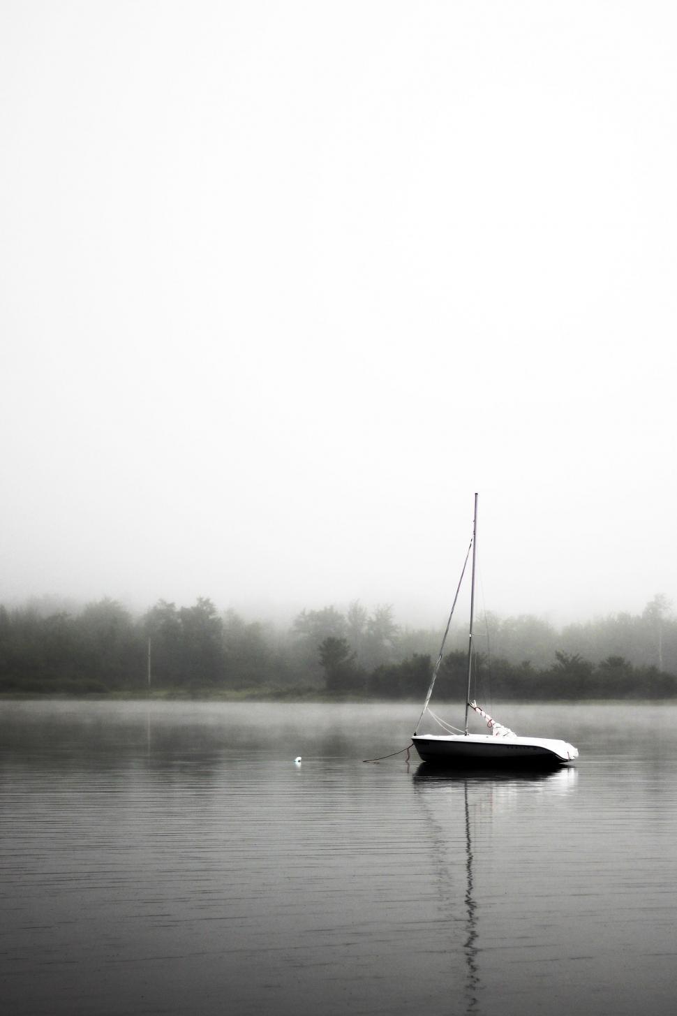 Free Image of Boat Floating on Lake Covered in Fog 