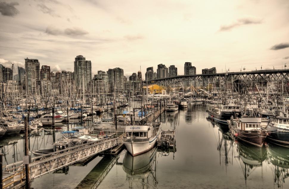 Free Image of Busy Harbor With Boats Under Bridge 