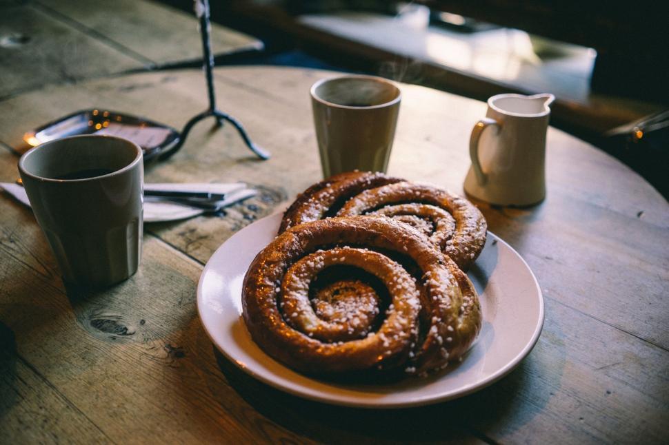 Free Image of Plate of Cinnamon Rolls on Wooden Table 