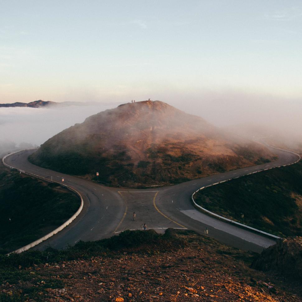 Free Image of Road Cutting Through Fog-Covered Mountain 