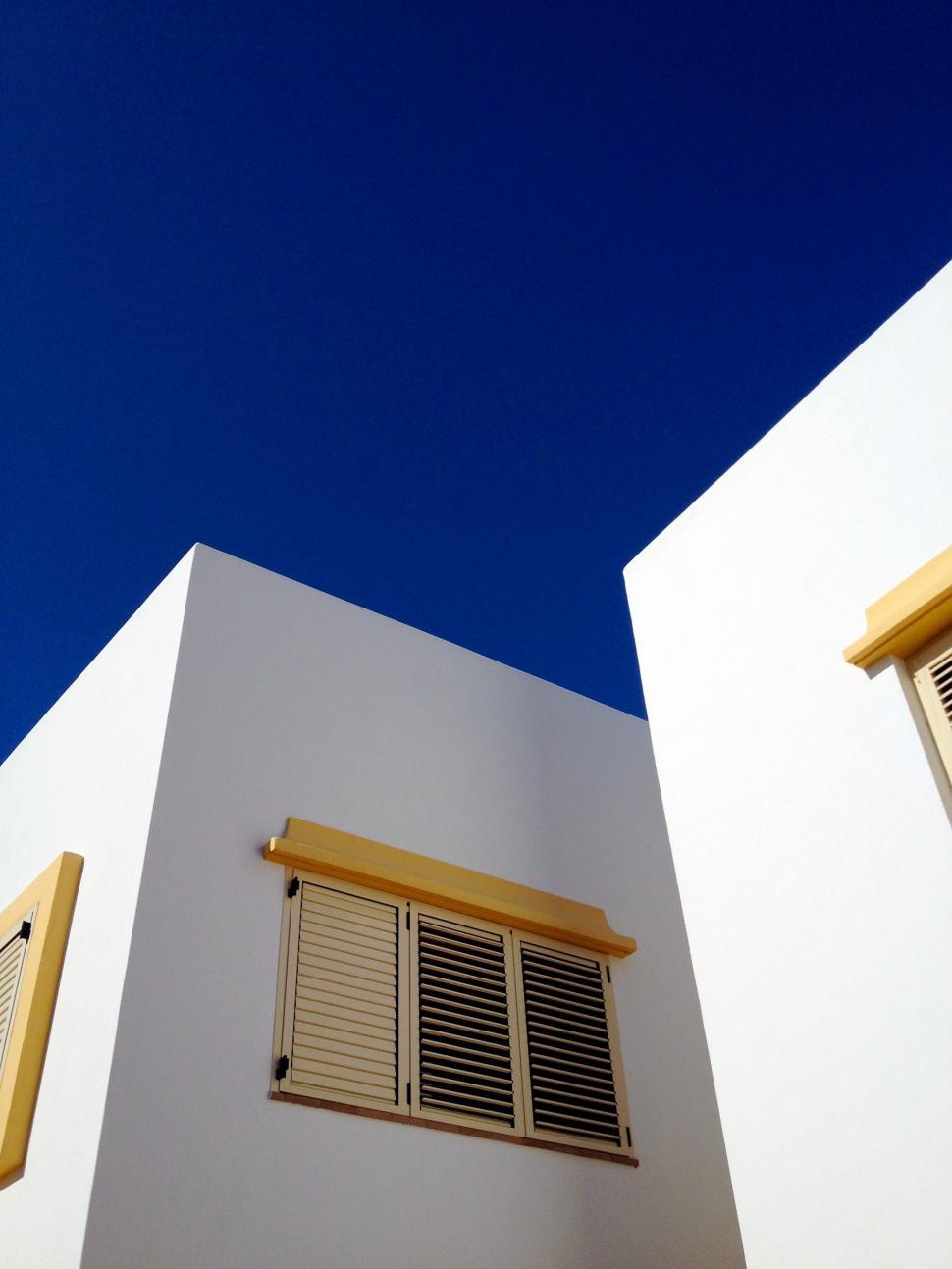 Free Image of White Building With Shutters and Window 