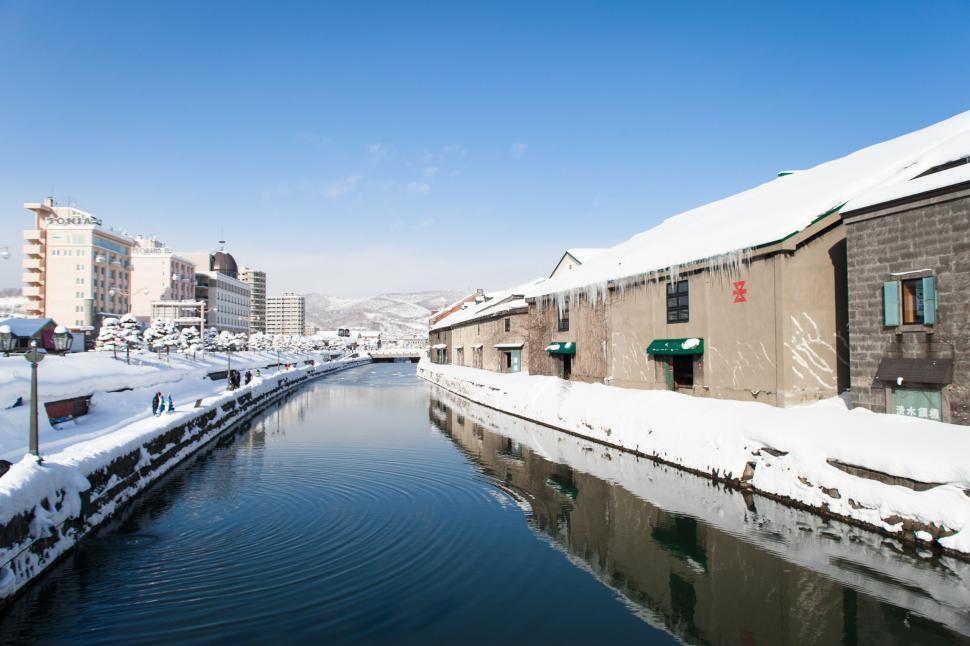 Free Image of River Running Through Snow-Covered City 