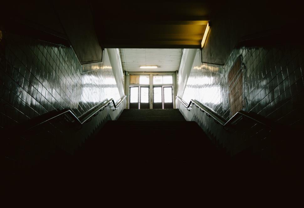 Free Image of Dark Hallway With Stairs Leading to Door 