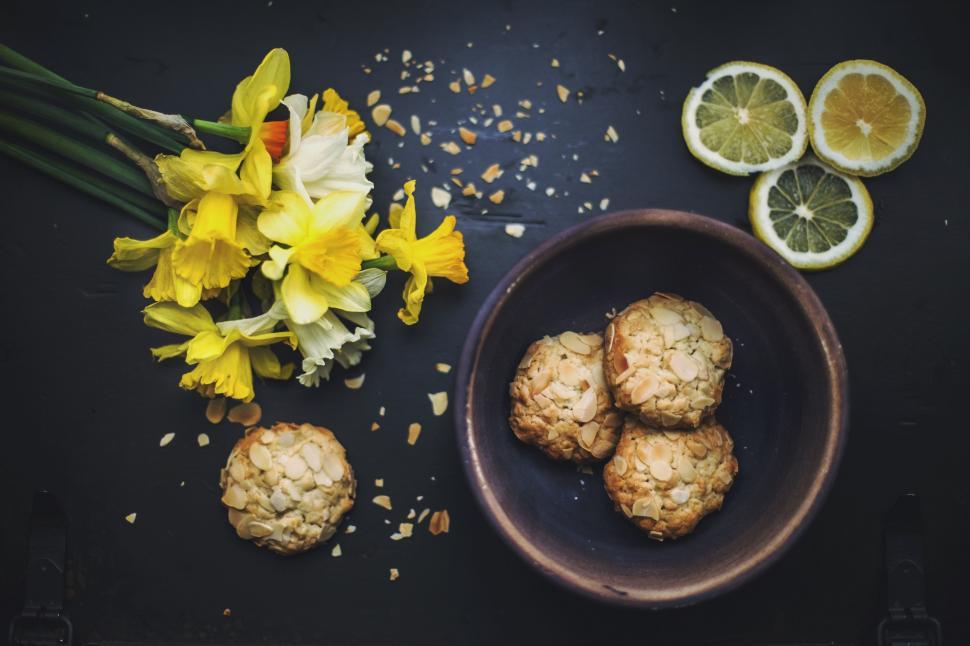 Free Image of Bowl of Cookies Next to Bunch of Flowers 