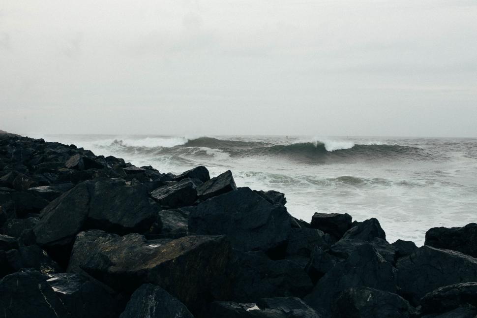 Free Image of Ocean Waves Crashing Against Rocky Coastline 