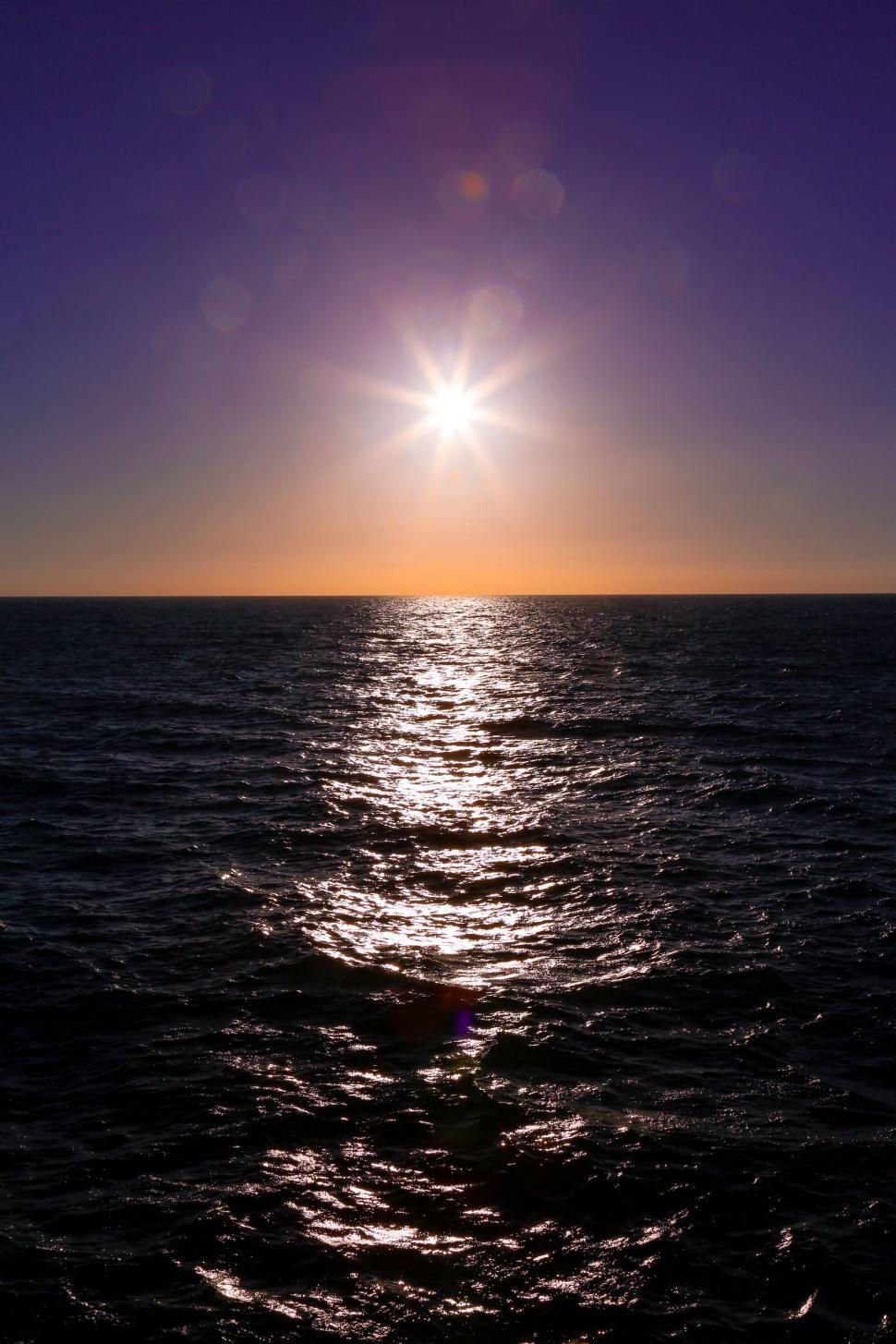 Free Image of Sun Setting Over Ocean 