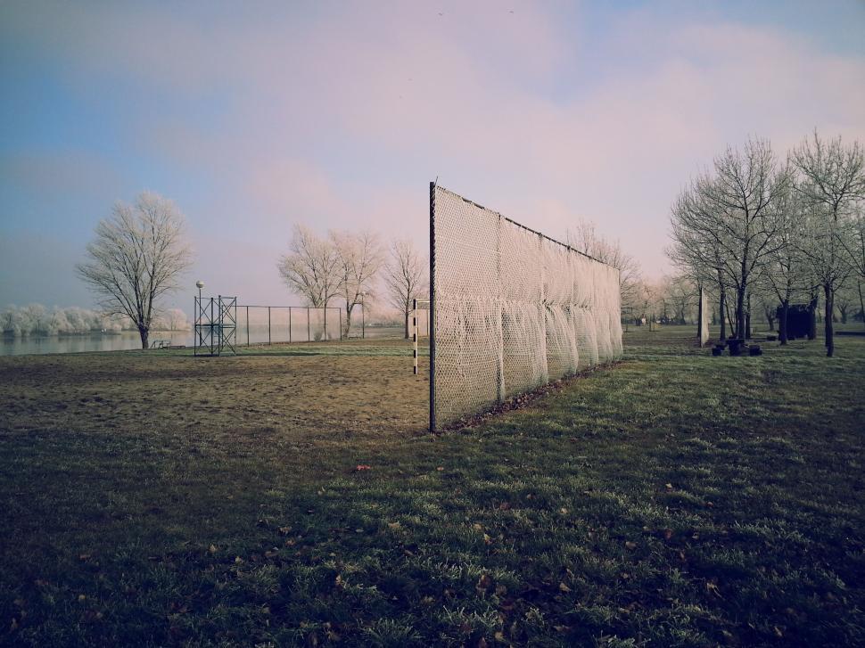 Free Image of Fence in a Grassy Field With Trees 