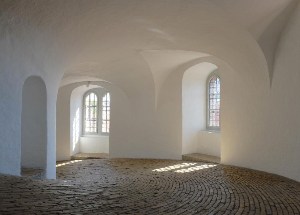Free Image of Room With Brick Floor and Arched Windows 