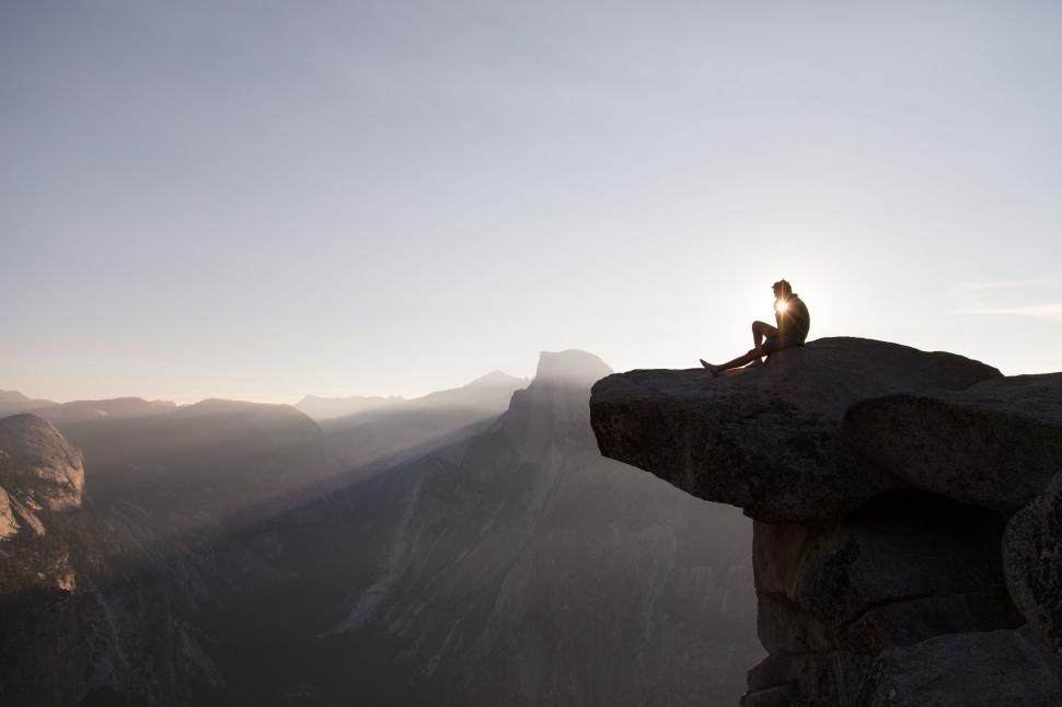 Free Image of Man Sitting on Top of Cliff 