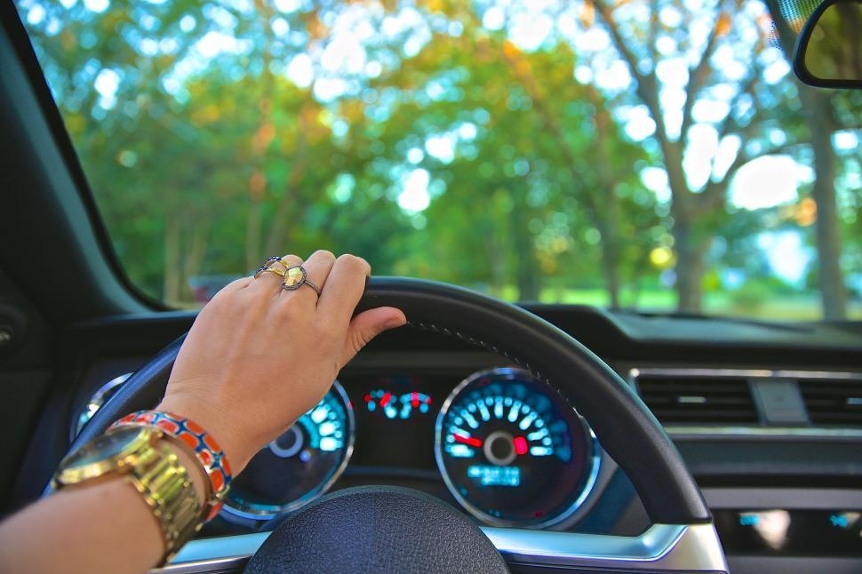 Free Image of Person Driving Car With Hand on Steering Wheel 