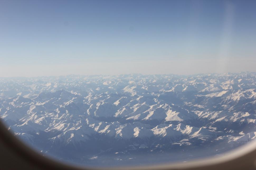 Free Image of Snowy Mountain Range View From Airplane Window 