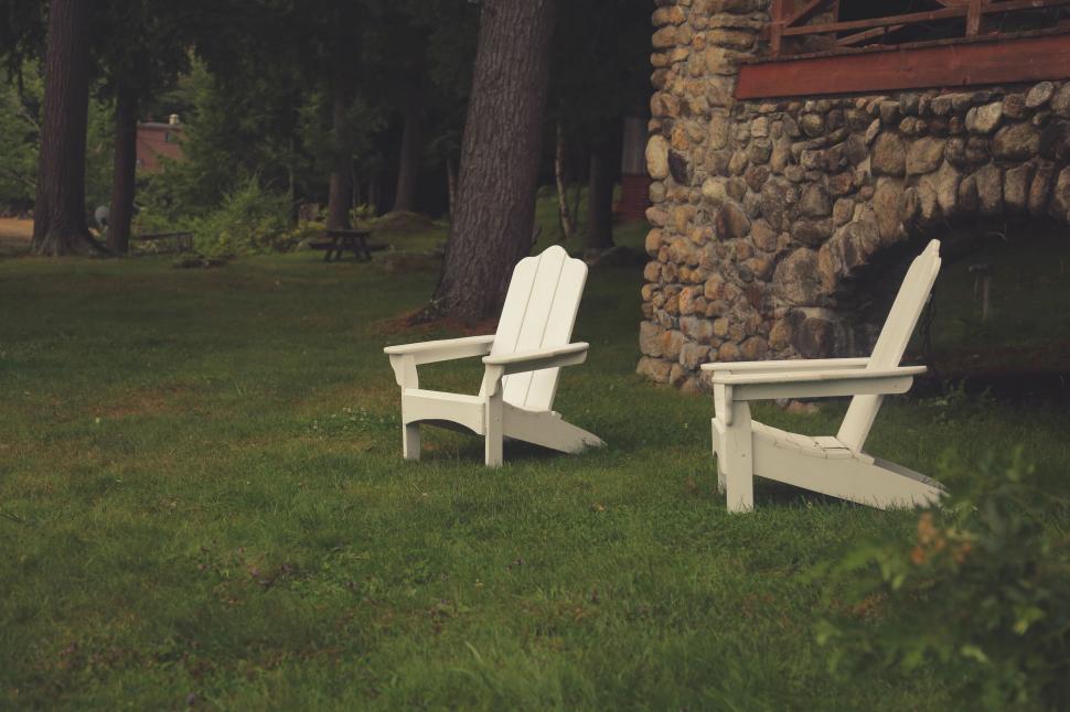 Free Image of Two White Chairs on Lush Green Field 