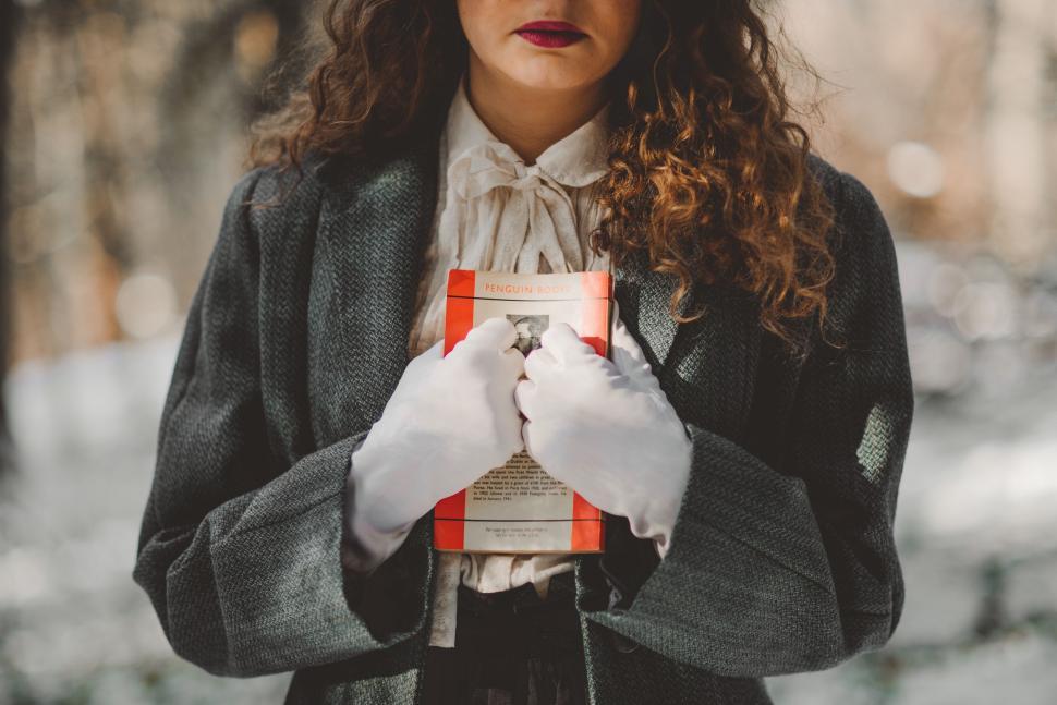 Free Image of Woman in White Gloves Holding a Box 