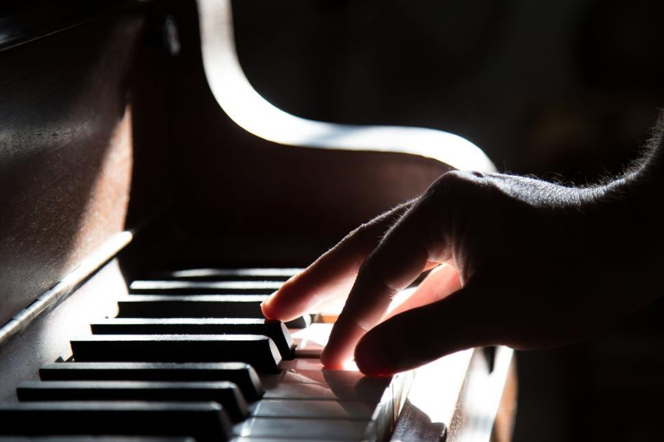Free Image of Person Playing Piano With Hand 