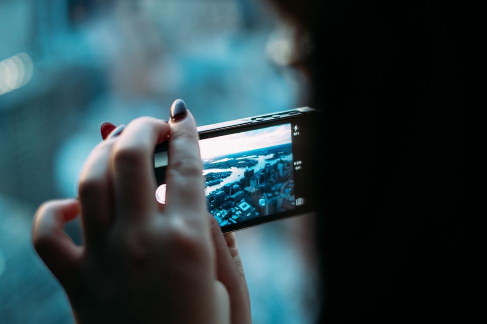 Free Image of Person Capturing Cityscape With Cell Phone 