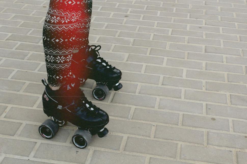 Free Image of A Pair of Roller Skates on a Brick Road 