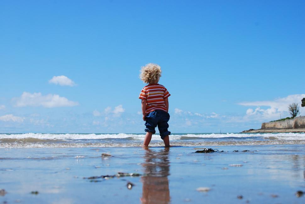 Free Image of Little Boy Standing in Sand 